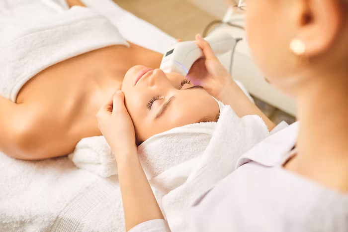 woman lying down while getting hydrofacial treatment